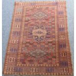 An early 20th century Turkish rug (possibly Southern?); three central lozenges against a