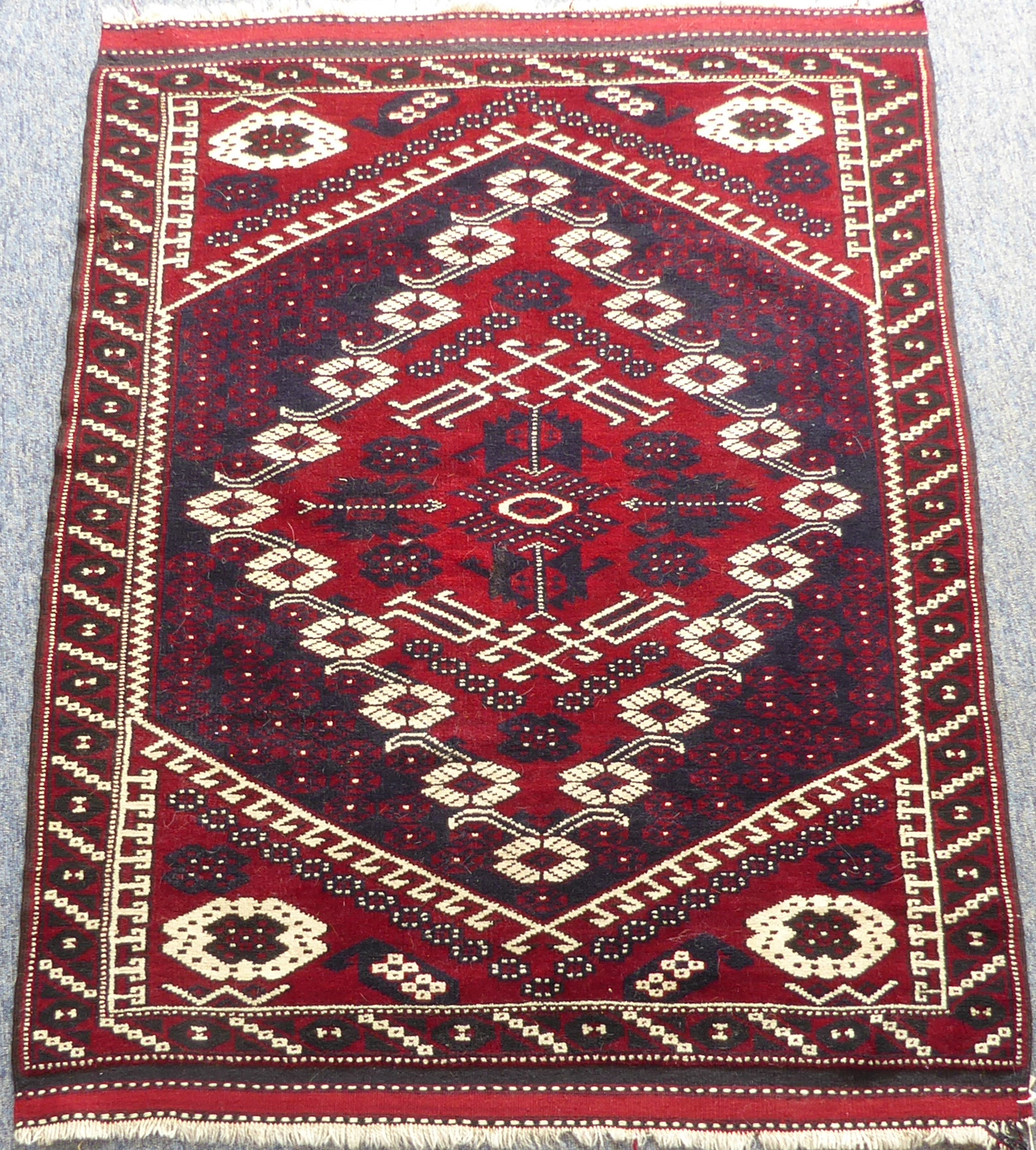 A modern 20th century Turkish Bergama rug; red ground, typical Bergama design with red central