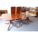 A fine Regency-style mahogany three-pillar dining table having two extra leaves: the reeded edge and