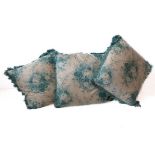 Three cushions in a cream and green patterned silk effect damask with a green floral print,