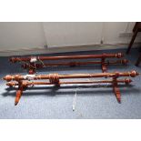 Two pairs of double curtain poles; the poles made of fluted stained oak with gilded details and