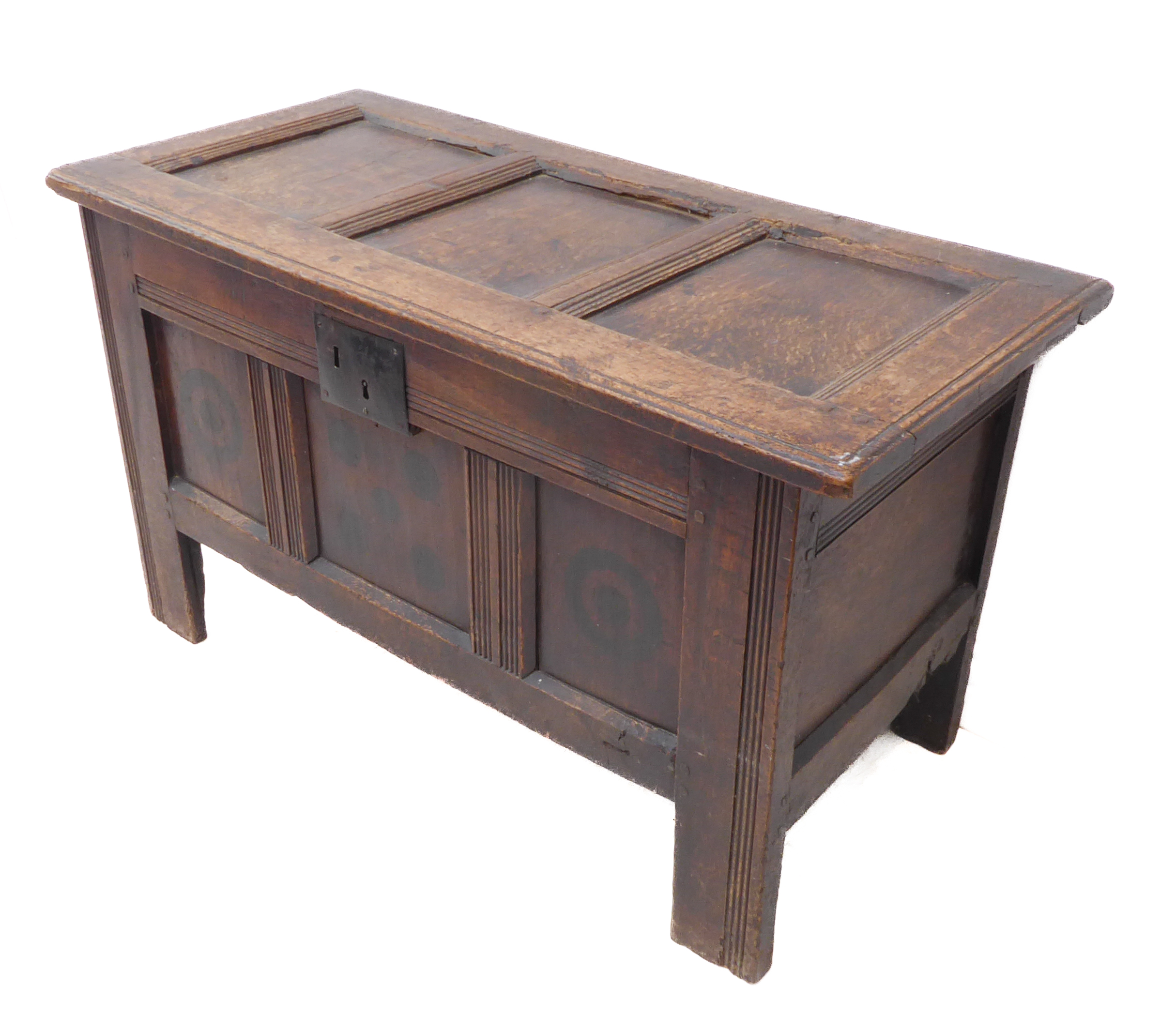 A late 17th / early 18th century oak chest of small proportions: the three-panel scratch moulded top