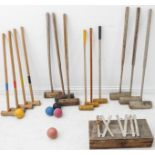Six antique and seven modern croquet mallets, five balls and a cased set of ironwork Clock Golf (