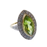 A fine quality 18-carat gold marquise-shaped ring set with a large peridot surrounded by diamonds,