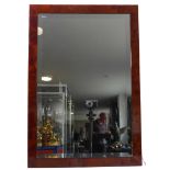 A modern wall-hanging looking glass within faux burr elm frame (frame 73.25cm x 55.5cm)