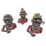 Three 19th century novelty money banks with rolling 'eyes' activated by turning the ears, rear lever