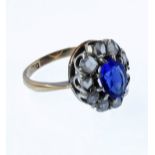 A lady's 9-carat yellow gold dress ring centrally-set with a hand-cut oval blue stone (untested)