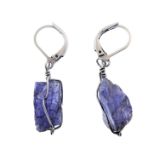 A pair of silver earrings mounted with natural tanzanite stone within wirework surrounds