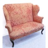 An early 20th century upholstered sofa in early 18th century Queen Anne style: the two winged