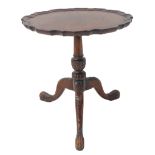A mahogany wine table in 18th century style (later): single piece pie-crust edged top above turned