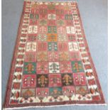 A large modern Persian Bakhtiar; overall compartmentalised design with stylised flowers to each