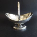 A fine neo-classical period hallmarked silver boat-shaped sugar basket; the reeded swing handle