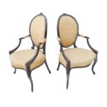 A pair of Hepplewhite-style (probably 19th century) mahogany open armchairs: the oval upholstered