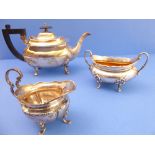 A three-piece hallmarked silver composite tea service: silver teapot by Walker & Hall, assayed