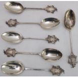 A matched set of six hallmarked silver spoons: cast armorial style finials with the motto 'Join