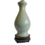 A Chinese celadon glaze porcelain vase of baluster form (now as a lamp) and on carved base (base