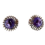 A pair of amethyst and wirework ear clips, each circular faceted amethyst coronet-set above the