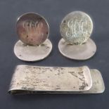 Two heavy hallmarked silver menu-holders / place names, each engraved 'MH', together with a