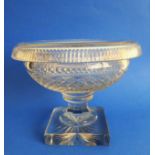 An early 19th century circular pedestal glass bowl: the averted, fluted lip above a hobnail-cut body