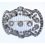 An early 20th century diamond-set brooch of shaped rectangular openwork design, the 13 cushion-