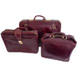 Two burgundy-leather travelling cases by Etienne Aigner with original protective bags (suitcase