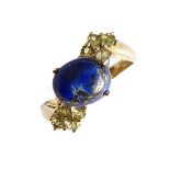 A 9-carat gold ring set with lapis lazuli and green garnets, ring size N