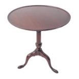 A Georgian circular dish-topped mahogany tilt-top occasional table; turned stem and on tripod base