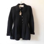 Redheart, England - a black knitted wool peplum jacket with revere collar and button front