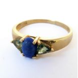 A 10-carat gold ring set with lapis lazuli and green sapphires, ring size N