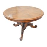 A mid-19th century circular walnut tilt-top loo table; the segmented figured walnut top with