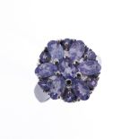 A 9-carat white-gold ring in a flower style setting, possibly tanzanite, ring size N (boxed)