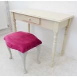 A modern cream-painted dressing table and stool; the dressing table with single central drawer (99cm