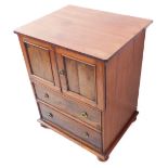 A 19th century mahogany side cabinet: the slightly overhanging top above two panelled doors and
