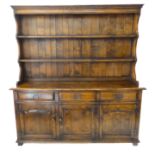 A good and large reproduction solid oak dresser: the shelved superstructure above three frieze