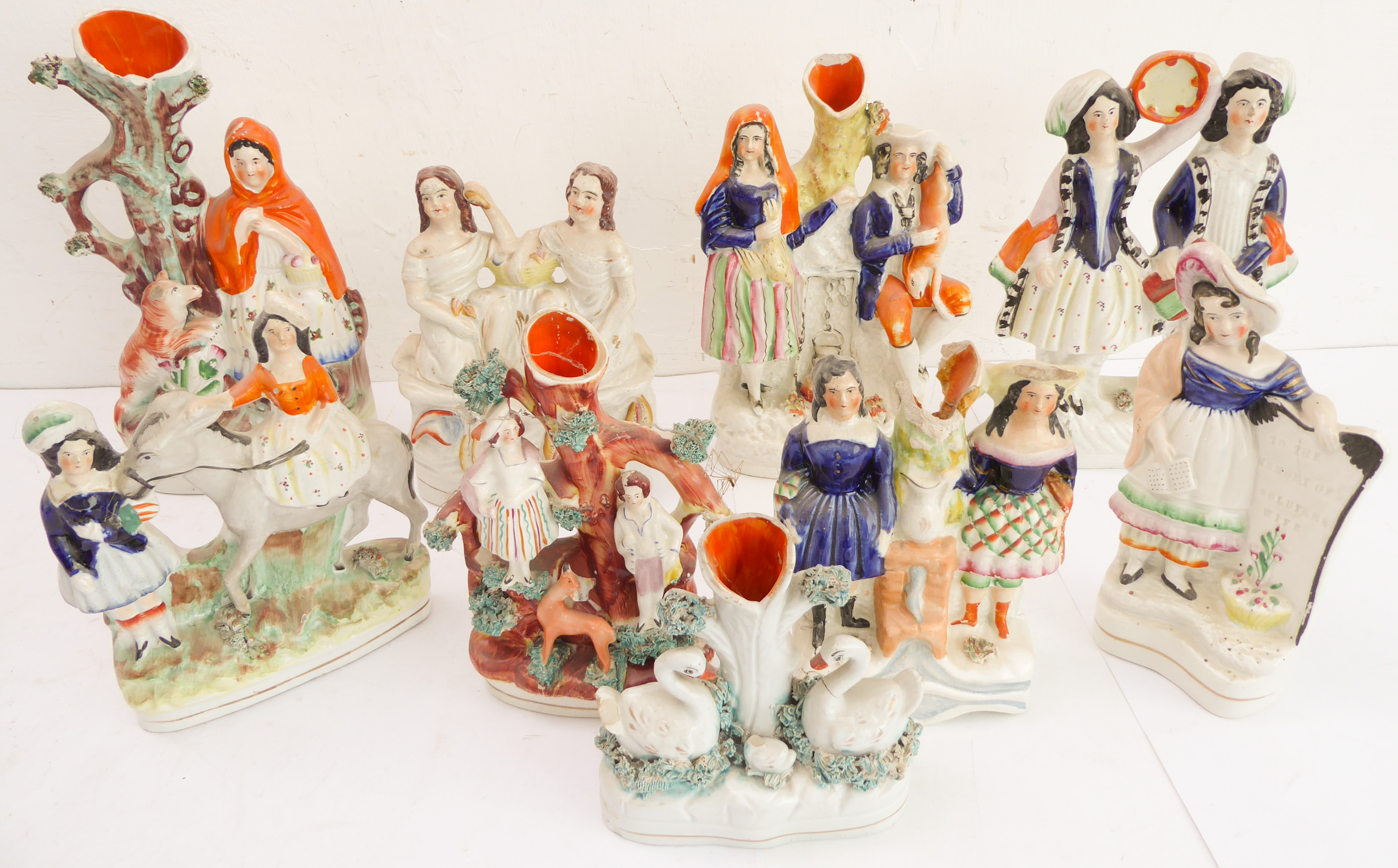 Nine 19th century hand-decorated flatback figures to include musicians, seafood sellers, a spill