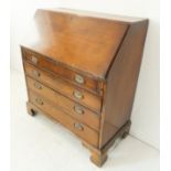 A late 18th century mahogany writing bureau: the angular fall opening to reveal fitted interior of