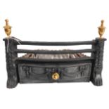 A small cast-iron fire-grate with brass-style finials and cast bow-fronted drawer below (46cm wide x