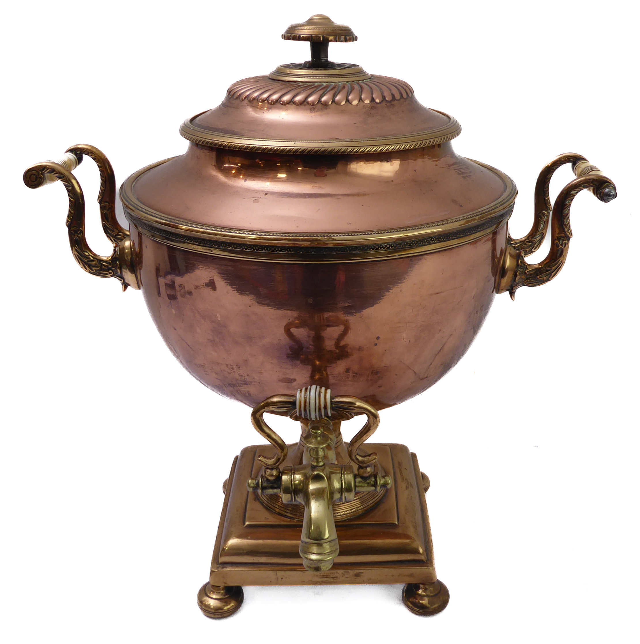 A large and impressive 19th century brass-mounted copper samovar; the circular lid lifting to reveal