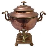 A large and impressive 19th century brass-mounted copper samovar; the circular lid lifting to reveal