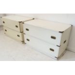 A pair of modern painted and brass mounted two-drawer military-style chests with recessed brass