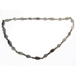 A large and heavy silver necklace modelled as pierced lozenges interspersed with ovals (60cm)