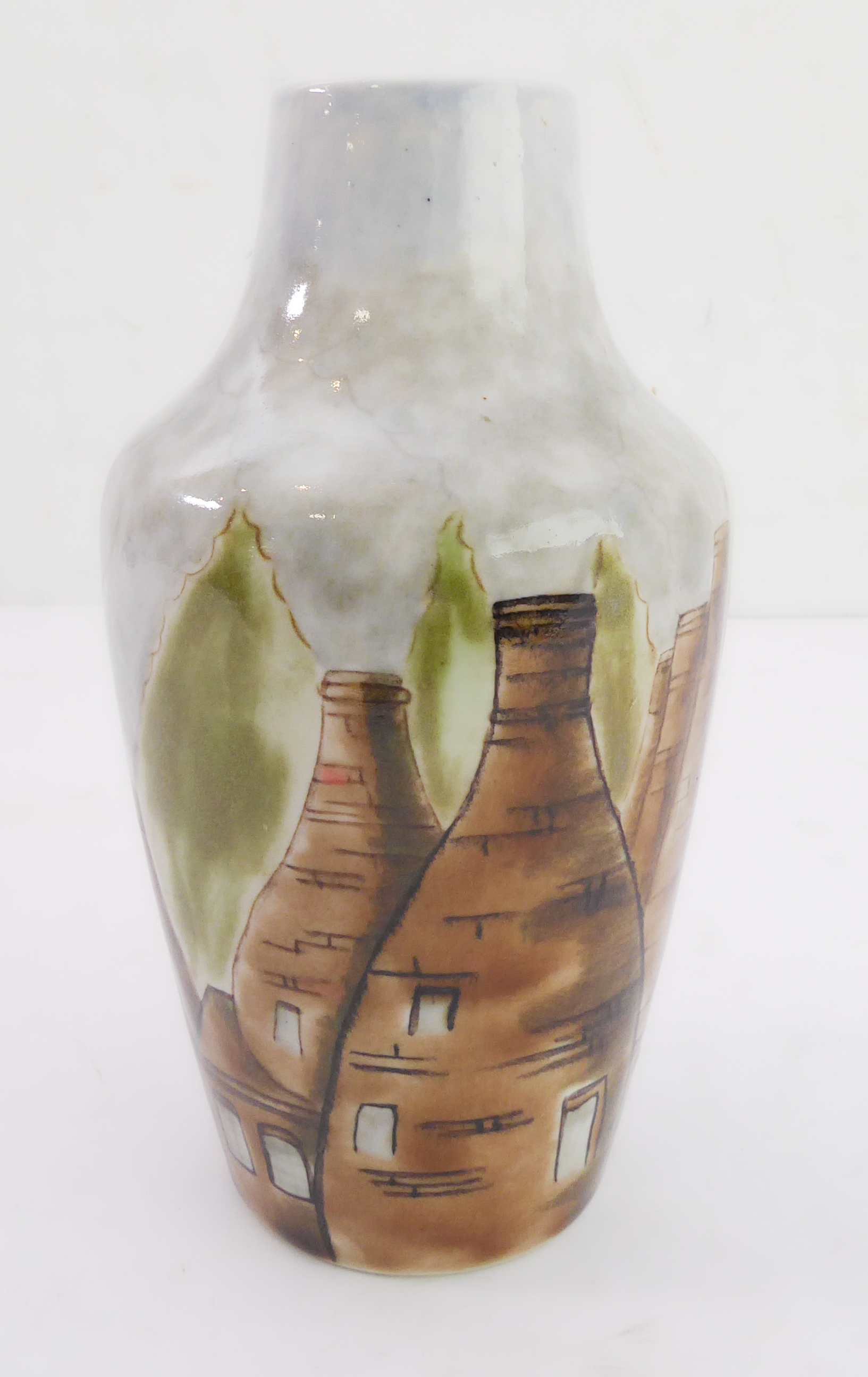 An unusual Cobridge stoneware vase hand-decorated with varying sized pottery kilns, impressed