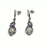 A stylish pair of silver earrings set with single pearls (boxed)