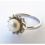 An 18-carat white gold, pearl and diamond cluster ring, ring size M/N