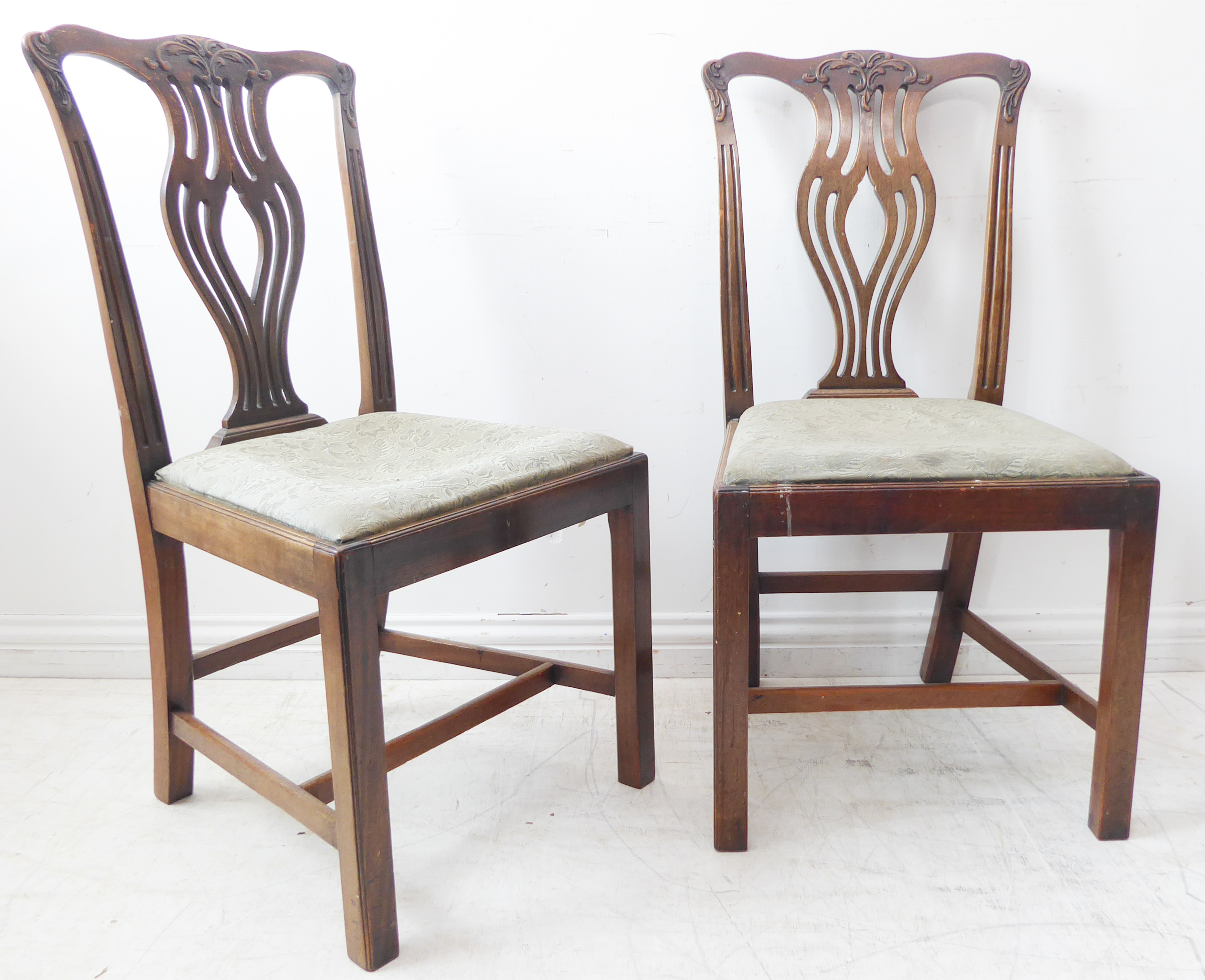 A pair of 18th century style (later) mahogany salon chairs; each with shaped top rail carved with