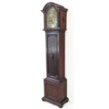 An oak-cased longcase clock: the 10.5 inch broken arch brass dial signed 'F A Chandler,