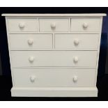 A modern white painted chest of drawers: moulded slightly overhanging top above three top drawers,