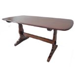 An Ercol oak dining table raised on shaped supports (152cm long x 76cm wide x 72cm high)