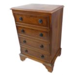 A modern reproduction Georgian-style crossbanded yew wood chest with four drawers on bracket feet (