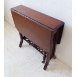 An Edwardian period walnut Sutherland table with unusual pierced rectangular stretcher (74cm